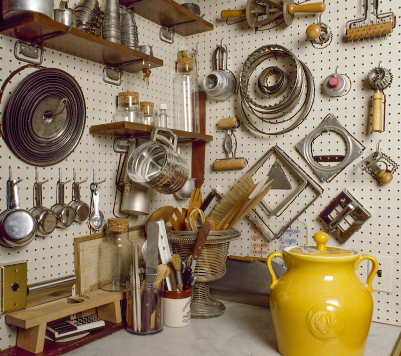 Pastry tools stored on wall in pantry.