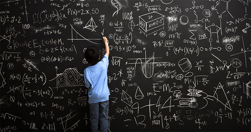 a student drawing math equations on the board